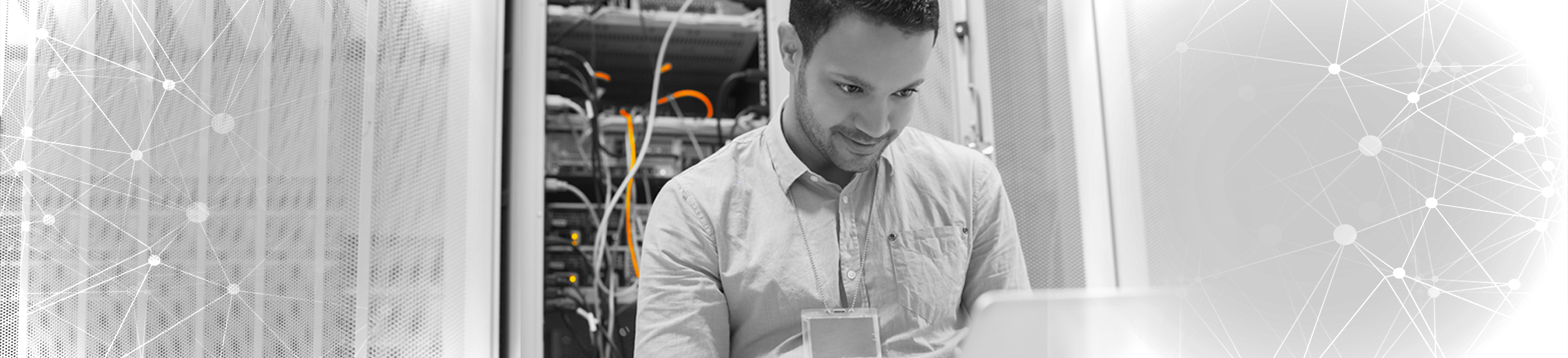 Man using laptop to check servers in data center